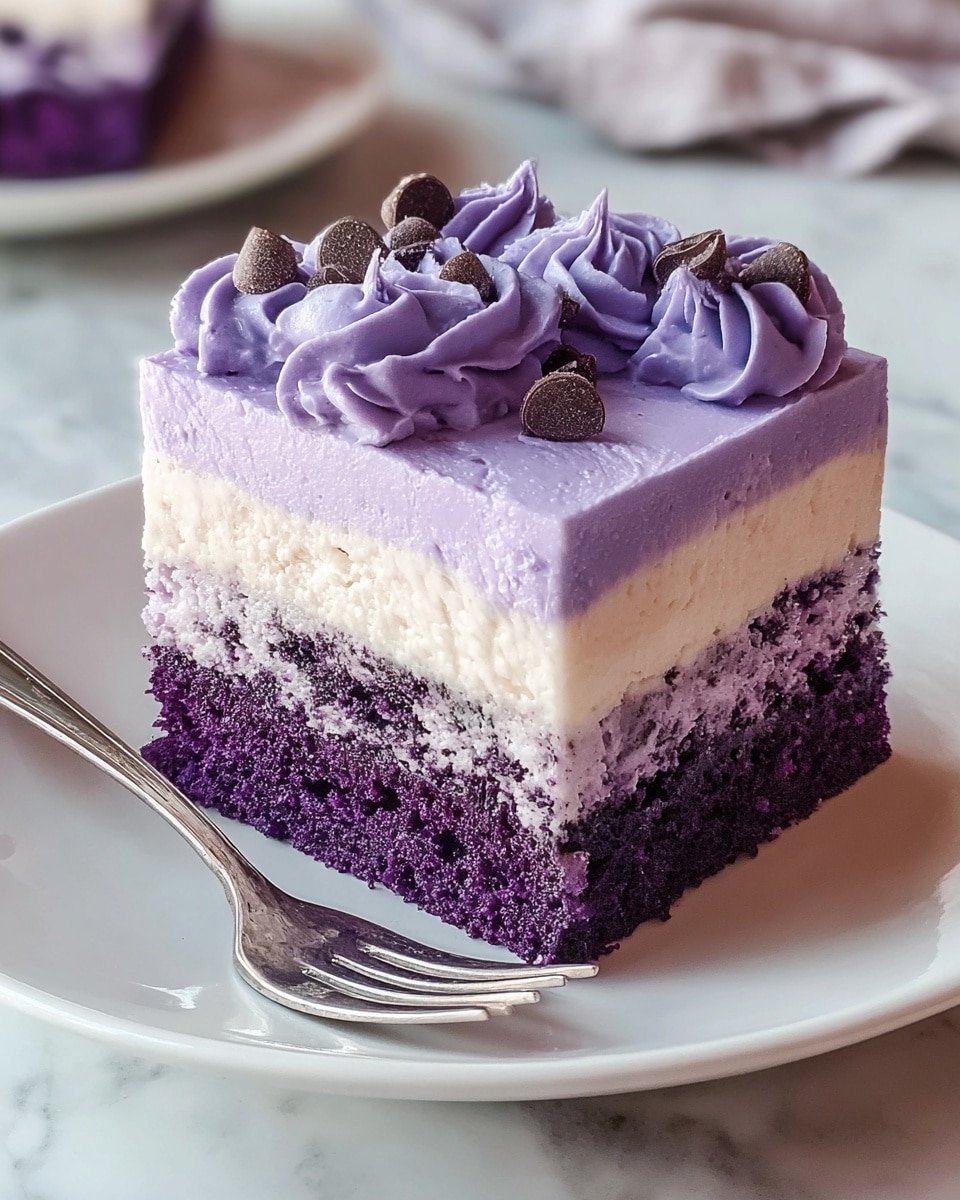 A three-layer square piece of cake is placed on a white plate with a silver fork beside it. The bottom layer is a dense purple cake with a crumbly texture. The middle layer is a creamy white filling with small bits of purple woven through it. The top layer is a smooth light purple frosting, decorated with darker purple piped swirls and small round chocolate pieces. The plate is set on a white marbled surface. Photo taken with an iphone --ar 4:5 --v 7