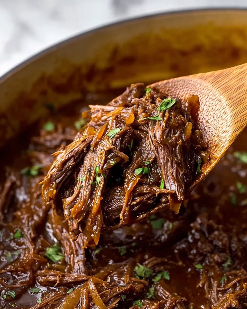A close-up view of shredded brown beef mixed with soft, cooked onions in a rich, glossy brown sauce, served on a wooden spoon lifted above a pan filled with the same beef and sauce. The beef strands are tender and fibrous, and the sauce looks thick and shiny with small green herb leaves scattered on top to add a fresh contrast to the dark brown colors. The background has a white marbled texture, emphasizing the meat's moist and savory texture. photo taken with an iphone --ar 4:5 --v 7