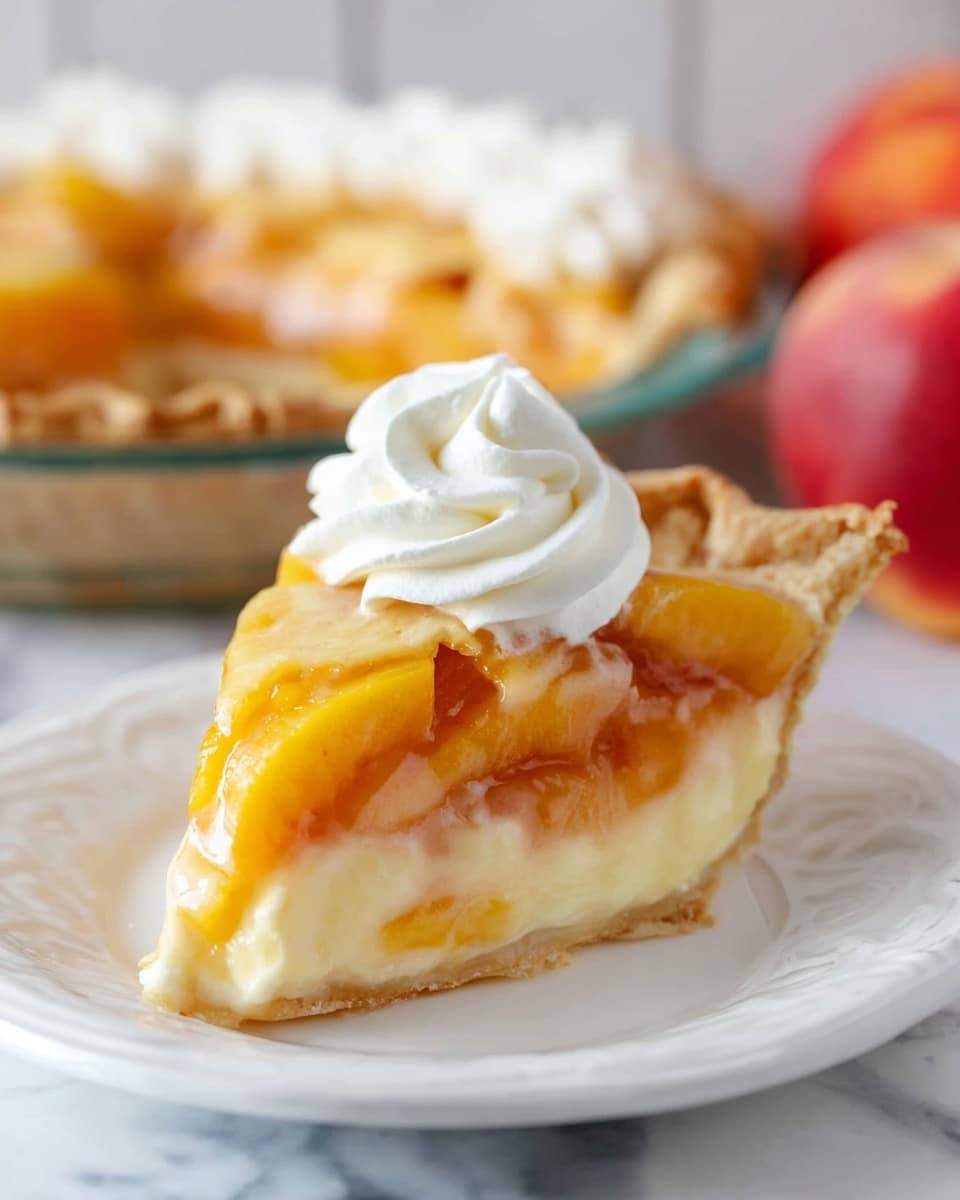 A close-up slice of peach pie sits in the center of a white plate on a white marbled surface. The pie slice shows three clear layers: a light golden brown flaky crust at the base, a thick creamy pale yellow custard layer in the middle, and a topping of glossy orange peach slices arranged evenly. On top of the peach layer, there is a dollop of fluffy white whipped cream, swirled in a spiral pattern. In the blurred background, the rest of the peach pie with the same layered structure is visible in a glass pie dish, along with a red peach. Photo taken with an iphone --ar 4:5 --v 7
