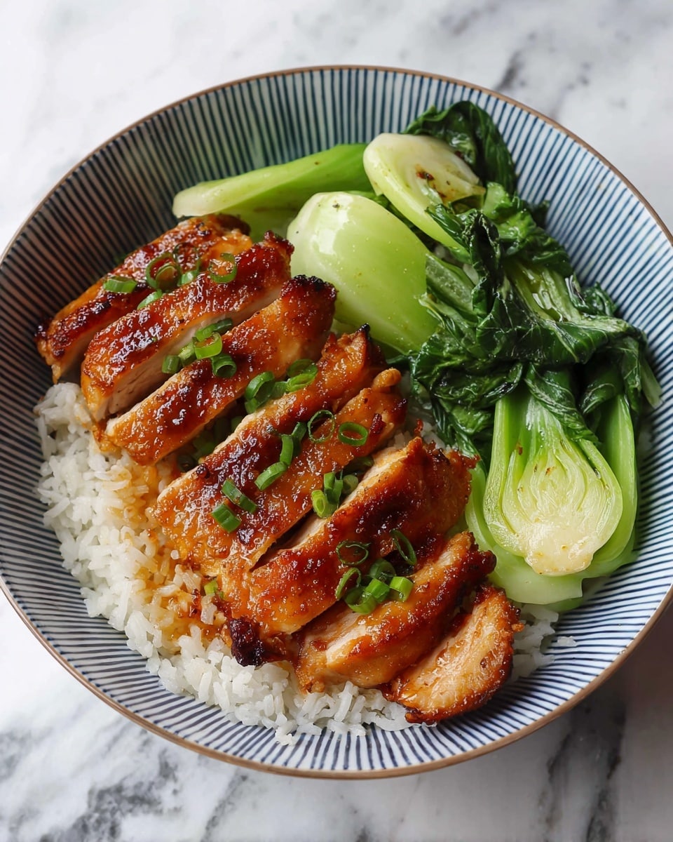 A white bowl with blue vertical stripes holds a layered dish. The bottom layer is fluffy white rice filling the bowl. On the right side, bright green bok choy leaves lay flat, showing a mix of darker leafy greens and lighter green stalks with a slightly shiny texture. On top of the rice to the left, there are six pieces of glazed chicken with a golden-brown, slightly crispy skin and a juicy inside, sprinkled with small green onion pieces for garnish. The bowl sits on a white marbled surface. photo taken with an iphone --ar 4:5 --v 7